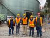 Utility Board and Council Members tour the empty south tank at the City’s reservoir site.
