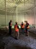 Utility Board and Council Members tour the empty south tank at the City’s reservoir site.