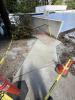 Concrete pathway poured back in place over storm drainage. 